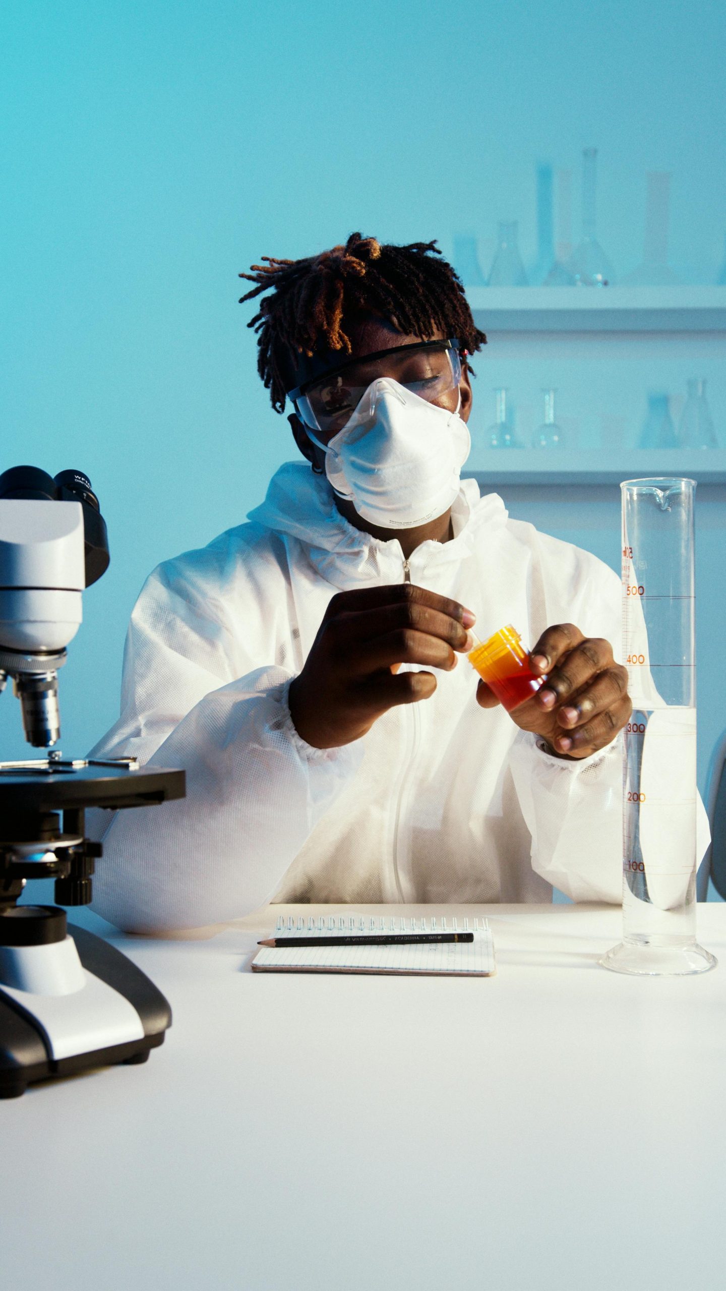 A scientist in protective gear conducting a chemical experiment in a lab.